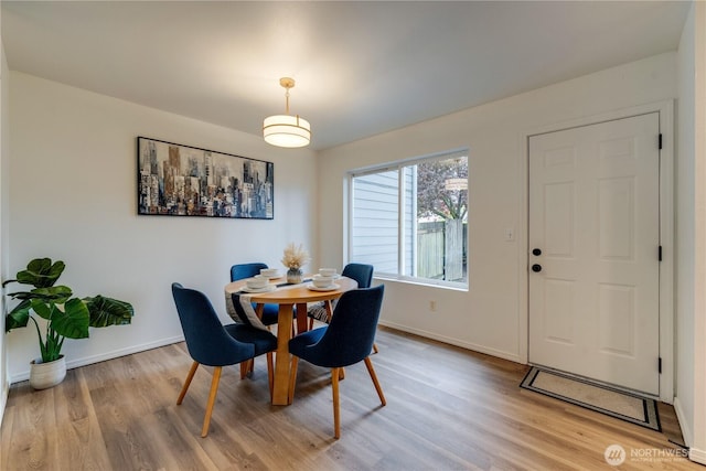 dining room with baseboards and light wood-style floors