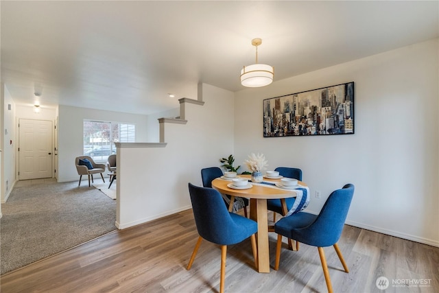 dining room featuring baseboards and wood finished floors