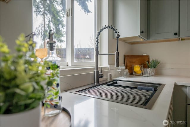 interior details featuring a sink and light countertops