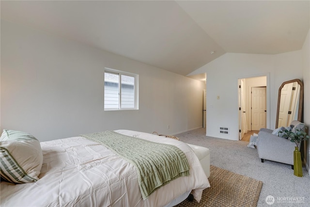 bedroom with visible vents, carpet, and lofted ceiling