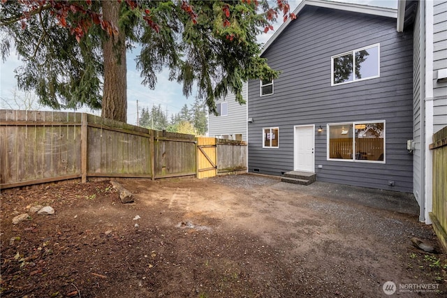 back of house with a patio, a gate, and fence