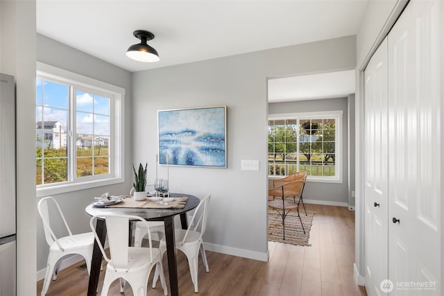 dining room featuring baseboards and wood finished floors