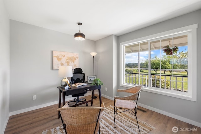 office space with wood finished floors and baseboards