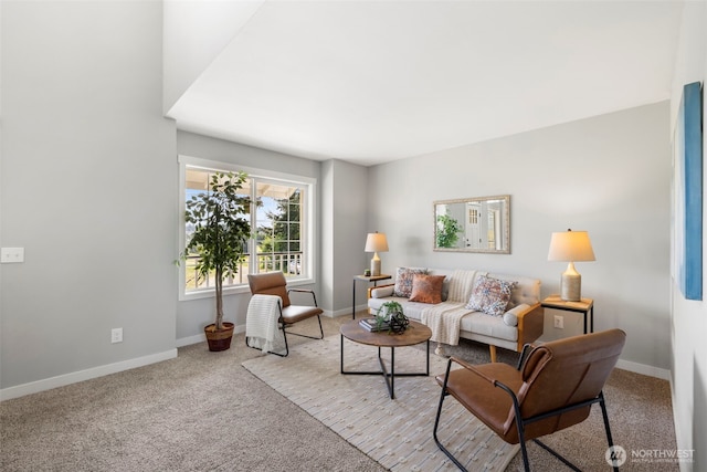 carpeted living area with baseboards