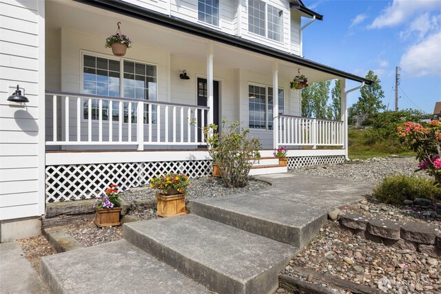 view of exterior entry featuring a porch