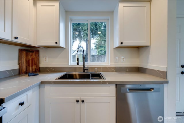 kitchen with a sink, white cabinetry, dishwasher, and light countertops