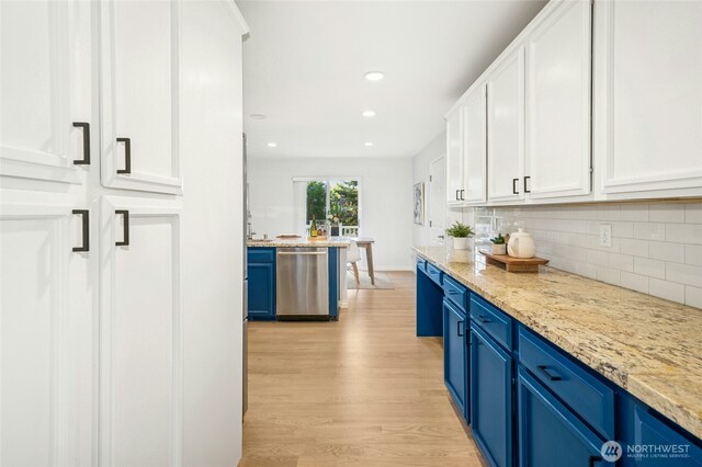 kitchen with decorative backsplash, blue cabinets, white cabinetry, dishwasher, and light wood-style flooring
