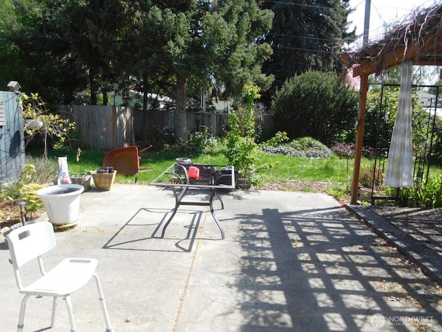 view of patio featuring fence
