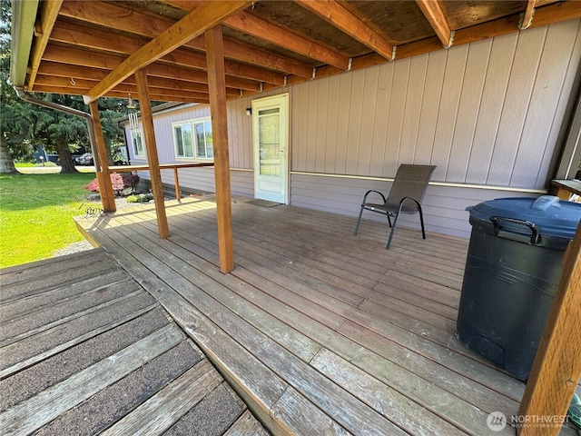 wooden terrace with a lawn