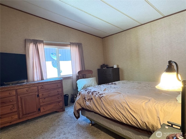 bedroom with carpet floors and lofted ceiling