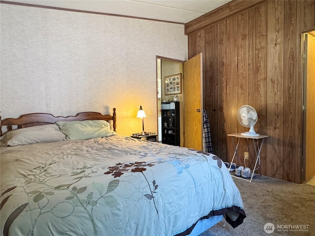 carpeted bedroom with ornamental molding and wooden walls
