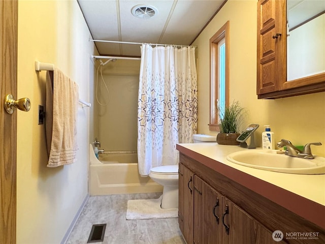 full bath featuring vanity, toilet, wood finished floors, and visible vents