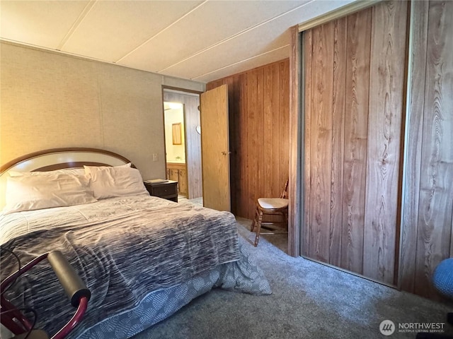 bedroom featuring wooden walls and carpet