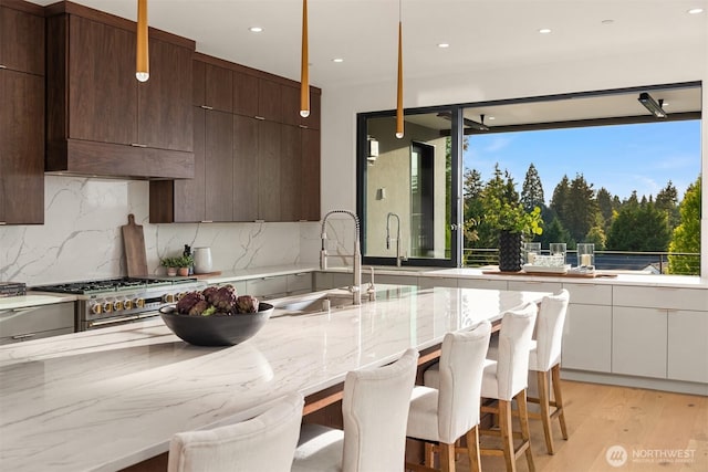 1032 89th Ave NE, Bellevue, WA 98004 - kitchen featuring a sink, modern cabinets, double oven range, and tasteful backsplash
