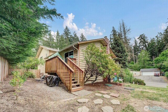 back of property featuring a chimney, stairway, fence, and a wooden deck