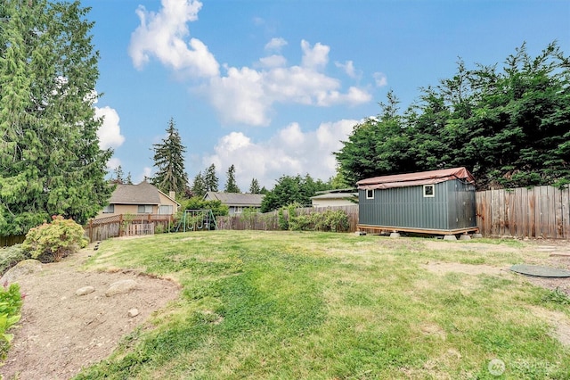 view of yard featuring a storage unit and an outbuilding