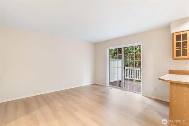 interior space with light wood-style floors and baseboards