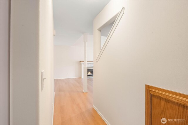 hallway with baseboards and light wood-type flooring