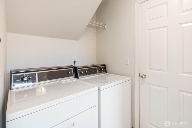 clothes washing area featuring laundry area and washer and clothes dryer
