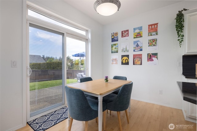 dining room featuring light wood-style floors and baseboards