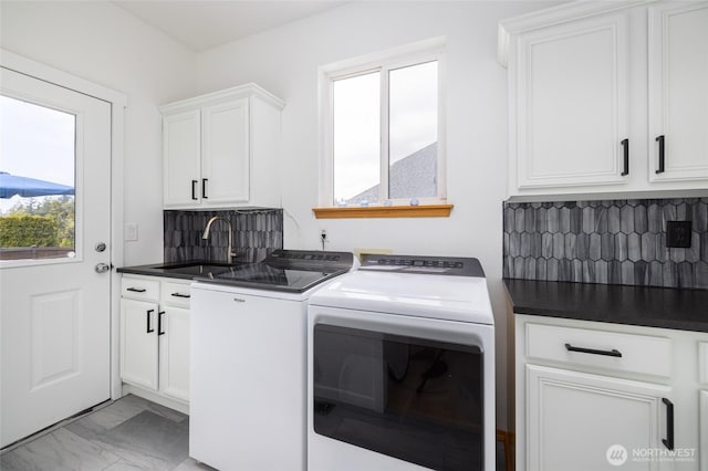 clothes washing area featuring a sink, marble finish floor, cabinet space, and washer and clothes dryer