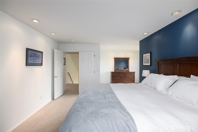 bedroom featuring baseboards, recessed lighting, and light colored carpet