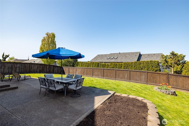 view of yard featuring a fenced backyard, a patio, and outdoor dining space