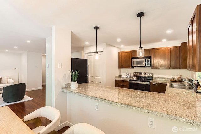 3018 128th Ave SE Unit 10, Bellevue, WA 98005 - kitchen featuring dark wood-style flooring, decorative light fixtures, a sink, baseboards, and stainless steel appliances