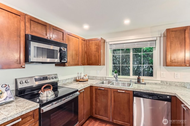 3018 128th Ave SE Unit 10, Bellevue, WA 98005 - kitchen with tile countertops, brown cabinets, wood finished floors, a sink, and stainless steel appliances