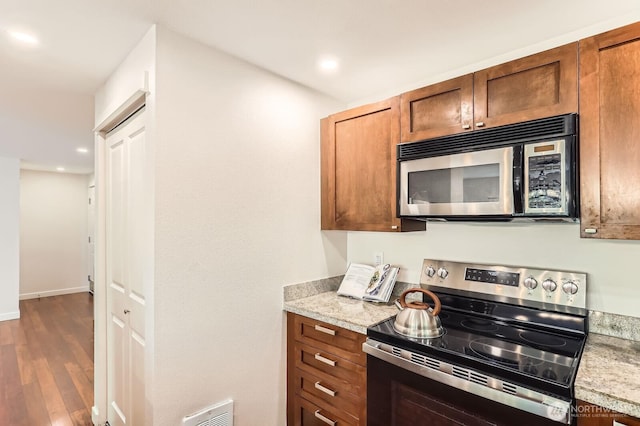 3018 128th Ave SE Unit 10, Bellevue, WA 98005 - kitchen with light countertops, stainless steel appliances, dark wood finished floors, and visible vents