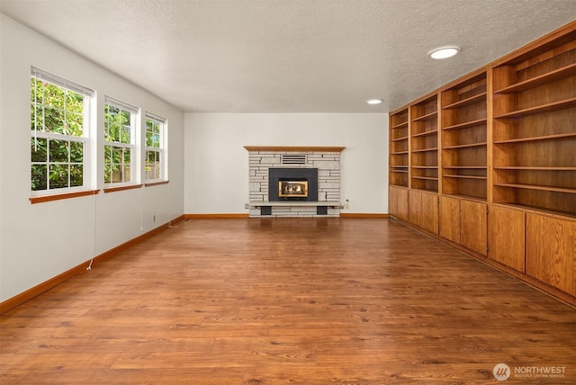 110 NW 110th St, Seattle, WA 98177 - unfurnished living room featuring baseboards, a textured ceiling, and wood finished floors