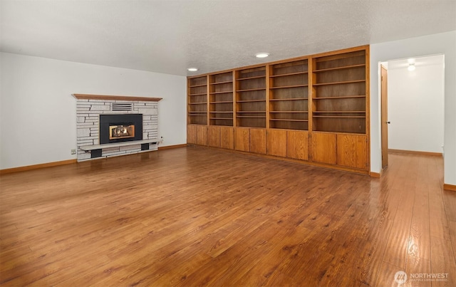 110 NW 110th St, Seattle, WA 98177 - unfurnished living room with recessed lighting, baseboards, a stone fireplace, and hardwood / wood-style floors