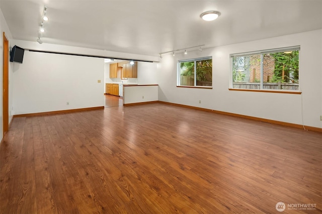 110 NW 110th St, Seattle, WA 98177 - unfurnished living room featuring baseboards, rail lighting, and wood finished floors