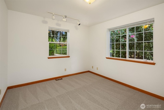 110 NW 110th St, Seattle, WA 98177 - empty room with baseboards, visible vents, track lighting, and carpet