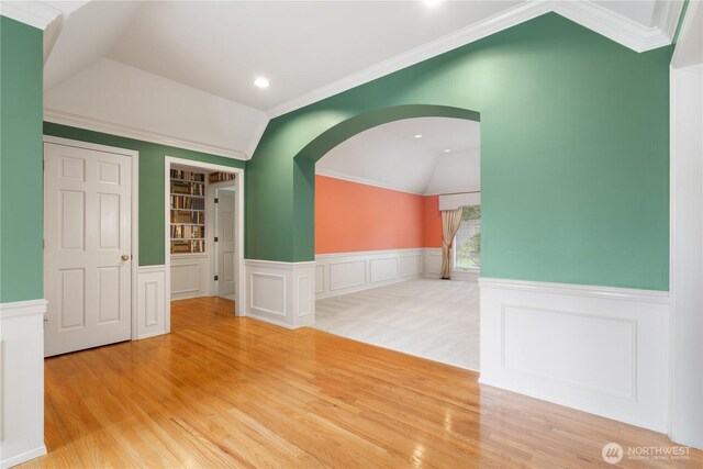 4799 171st Ave SE, Bellevue, WA 98006 - spare room with arched walkways, wainscoting, wood finished floors, and lofted ceiling
