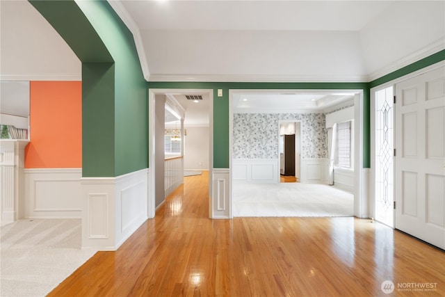 4799 171st Ave SE, Bellevue, WA 98006 - entrance foyer featuring arched walkways, visible vents, light wood finished floors, and a wainscoted wall