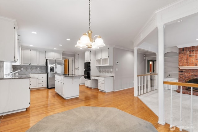 4799 171st Ave SE, Bellevue, WA 98006 - kitchen with a kitchen island, black appliances, white cabinets, and a chandelier