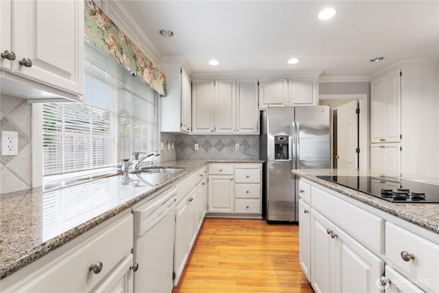 4799 171st Ave SE, Bellevue, WA 98006 - kitchen featuring black electric stovetop, stainless steel fridge, white cabinets, a sink, and dishwasher