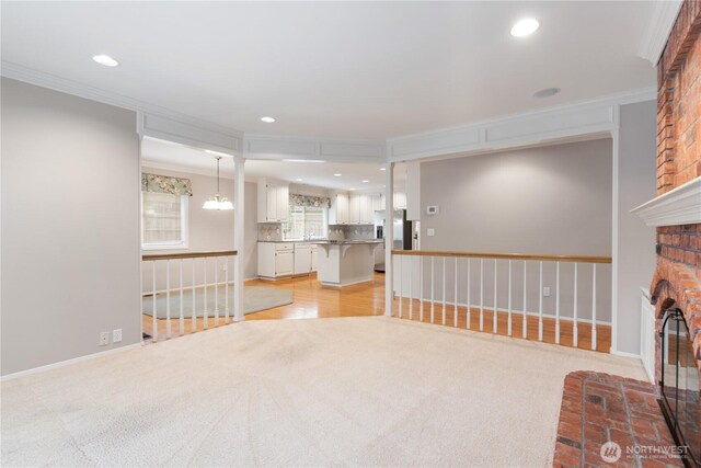 4799 171st Ave SE, Bellevue, WA 98006 - unfurnished living room with ornamental molding, light carpet, and a brick fireplace