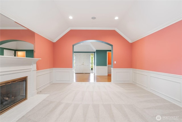 4799 171st Ave SE, Bellevue, WA 98006 - unfurnished living room with carpet floors, wainscoting, a fireplace with flush hearth, recessed lighting, and arched walkways