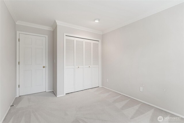 4799 171st Ave SE, Bellevue, WA 98006 - unfurnished bedroom with crown molding, baseboards, a closet, and light colored carpet