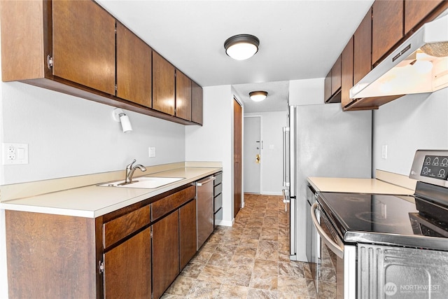 1346 Orleans, Bellingham, WA 98229 - kitchen featuring under cabinet range hood, stainless steel appliances, a sink, light countertops, and stone finish flooring