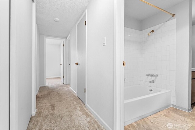 1346 Orleans, Bellingham, WA 98229 - bathroom with shower / bathtub combination, baseboards, and a textured ceiling