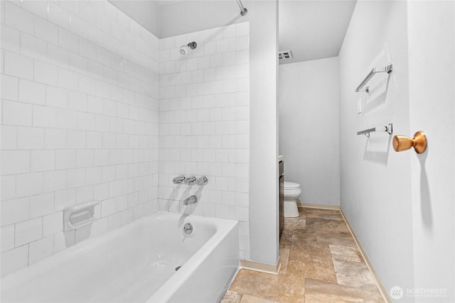 1346 Orleans, Bellingham, WA 98229 - bathroom with stone finish floors, toilet, baseboards, and bathtub / shower combination