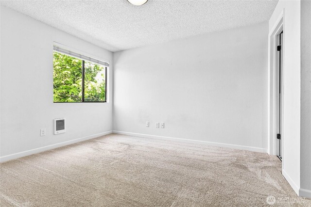 1346 Orleans, Bellingham, WA 98229 - spare room with a textured ceiling, carpet flooring, heating unit, and baseboards