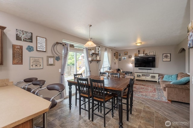 dining area featuring stone finish flooring
