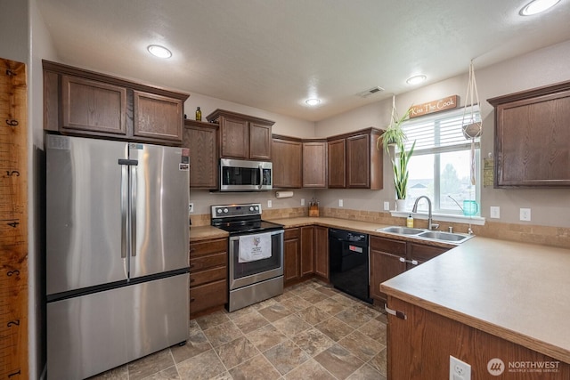 kitchen with a sink, light countertops, stainless steel appliances, recessed lighting, and visible vents