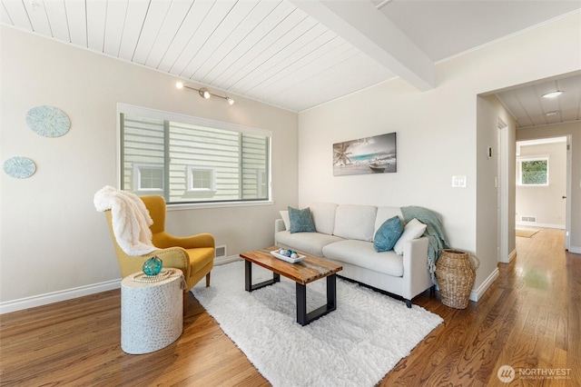 living area with baseboards, wood ceiling, wood finished floors, and visible vents