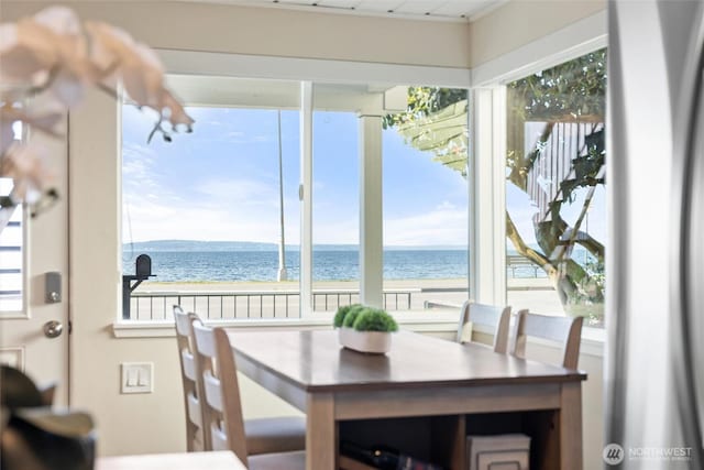 dining area featuring a water view