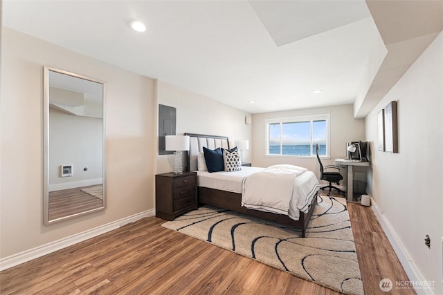 bedroom featuring baseboards and wood finished floors